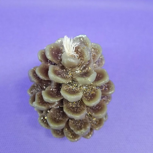 Decorative candle in pine cone shape like new