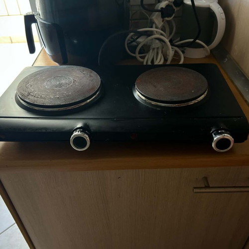 Electric tabletop stove with two burners used