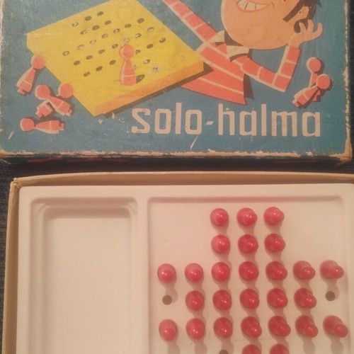 Solo-Halma vintage board game with three jumps on pegs
