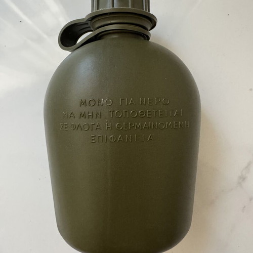 Military-style khaki water canteen with cap