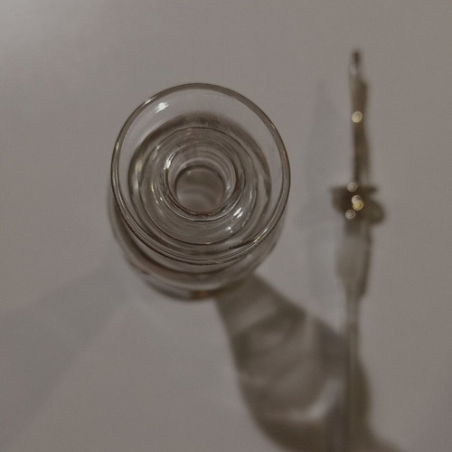 Glass perfume bottle used with golden accents and cap