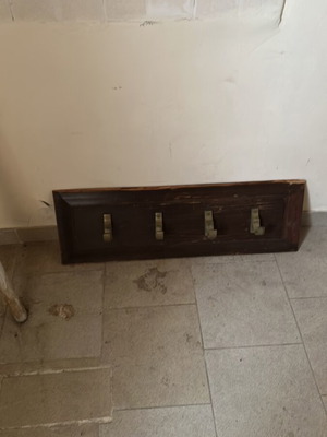 Wooden hanger with brass hooks used