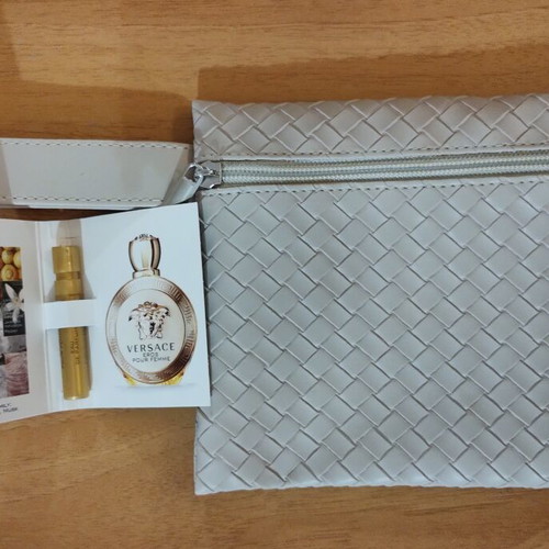 Everyday beige toiletry bag with woven texture and Versace Eros Pour Femme perfume sample