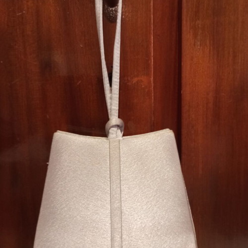 Silver satin evening bag with bow and wrist strap