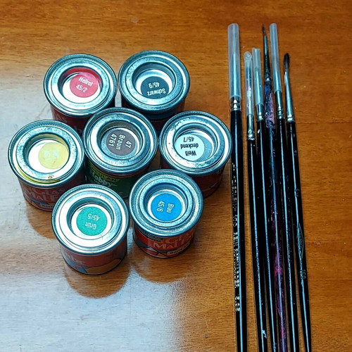 Various jars with colors and brushes