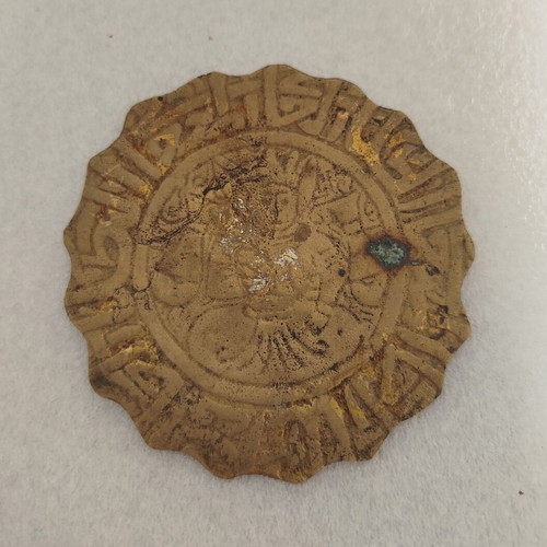 Small vintage brass object used with carved figure
