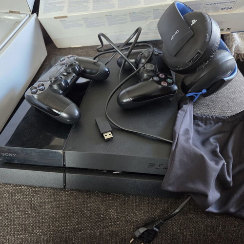 Sony PlayStation 4 500GB console used with 2 controllers, headset, USB hub, and 3 games
