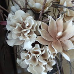 Decorative floral arrangement with large earth-tone flowers