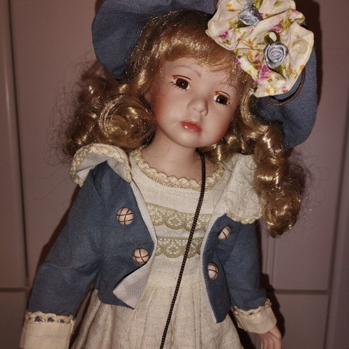 Porcelain doll rare, new with hat and dress