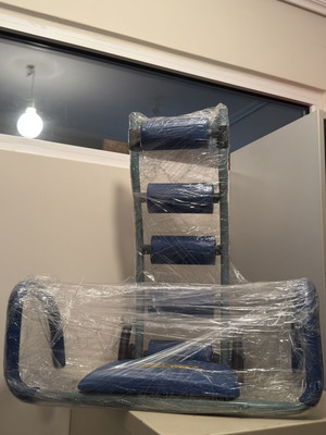 Abdominal Exercise Machine used with soft support cushions and comfortable arms