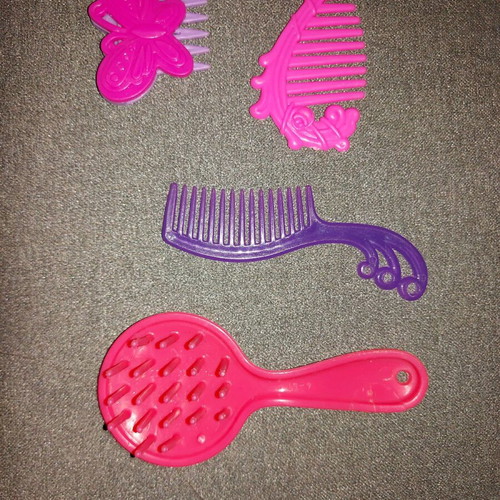 Combs used, missing one tooth on brush, sold separately