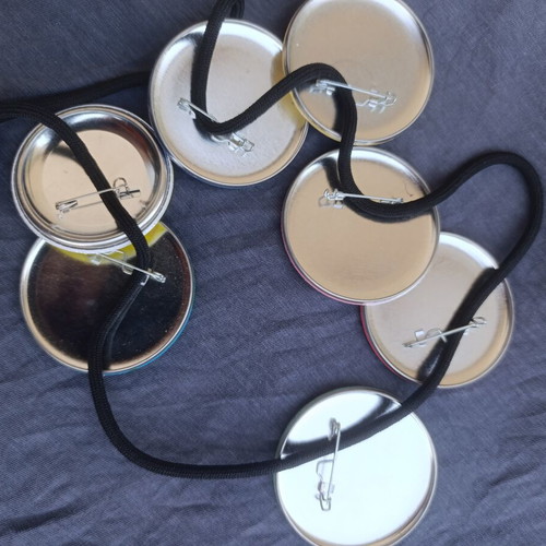 Large colorful pins set of 7 on safety cord, like new