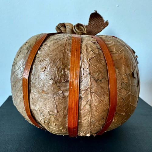Decorative pumpkin wrapped with dried leaves like new