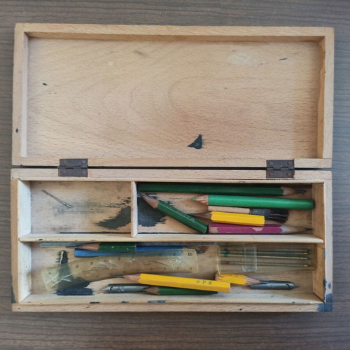 Wooden stationery box with used pencils and ink cartridges set