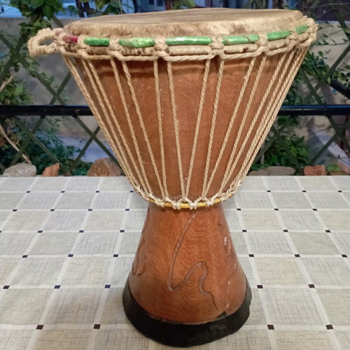 Traditional African djembe drum, carved wood and natural skin