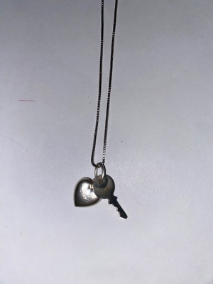 Silver necklace with heart and key used