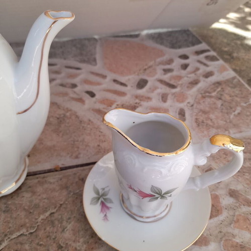 Porcelain tea set collectible with gold details and small vases like new