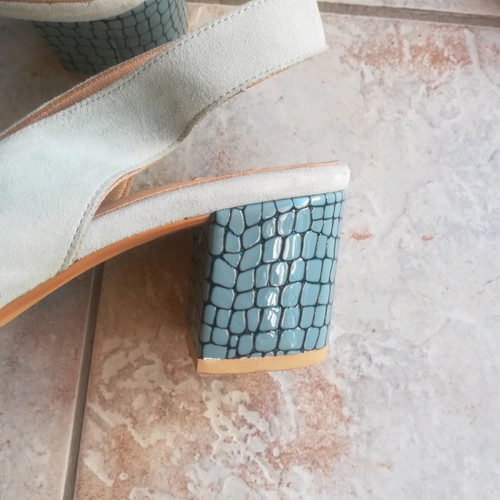 Sparta platforms used, blue with animal print heel