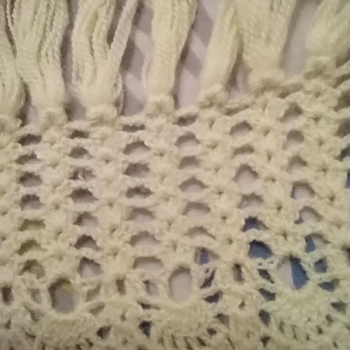 Knitted scarf handmade in soft yellow color with fringes