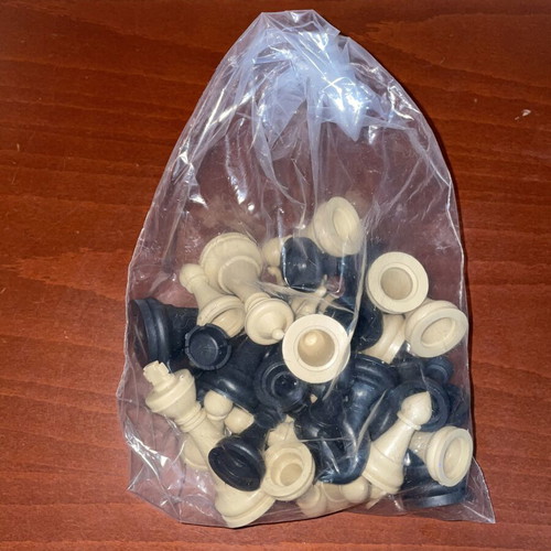 Set of black and white plastic chess pieces