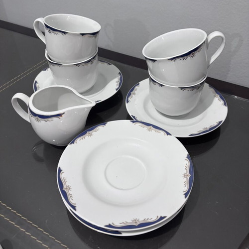 Tea set with 4 cups, saucers and creamer like new
