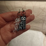 Skeleton cat earrings, pair, black and transparent