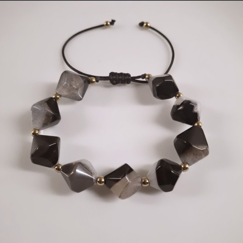 Handmade bracelet with natural black and gray stones and gold details