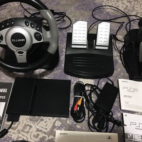 Playstation 2 Slim like new with steering wheel and 3 games