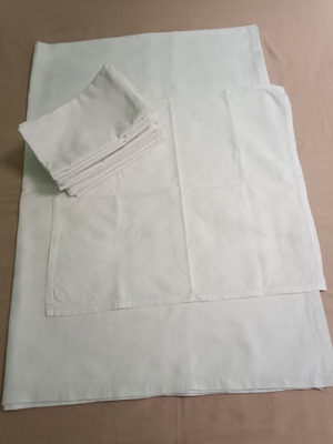White tablecloth set with 12 used embossed napkins