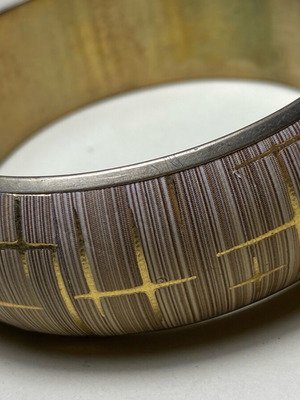 Bracelet used with beige and gold tone patterned design