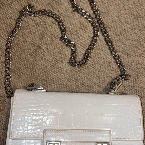 White crossbody bag used with silver details