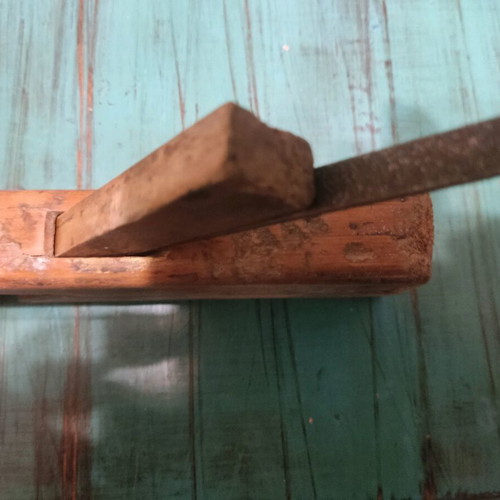 Wooden plane used with signs of wear, about 25 centimeters