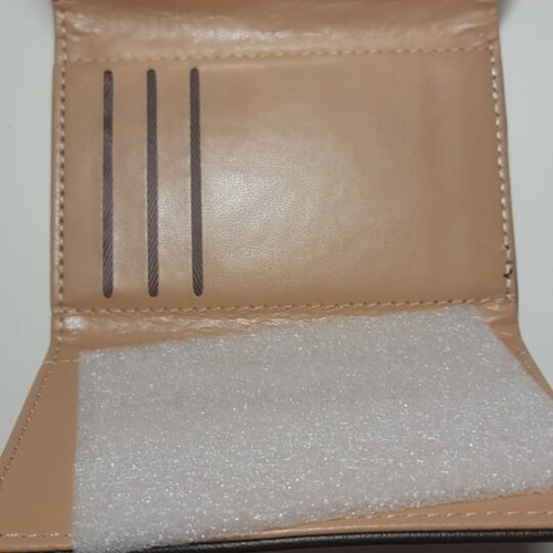 Black wallet new with gold emblem and beige lining