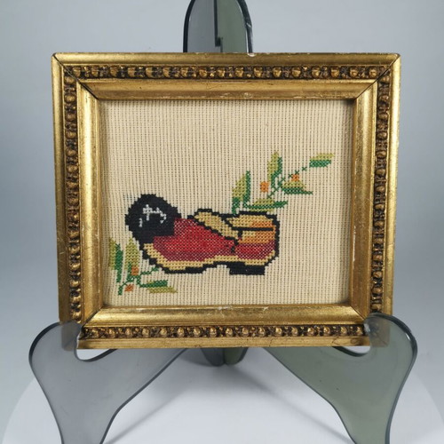 Vintage embroidered frame with traditional tsarouhi used