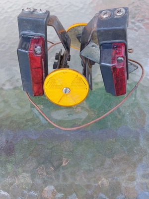 Hella trailer rear lights set used with orange reflectors and metal bases