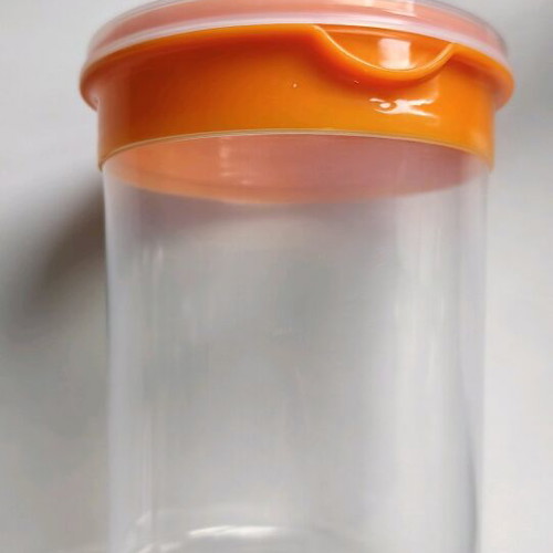 Storage container round like new, transparent with orange lid