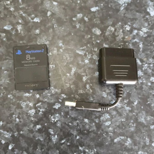Sony PlayStation 2 console used with Thrustmaster racing wheel and accessories