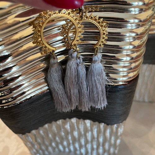 Dangling earrings used with grey tassels and gold details