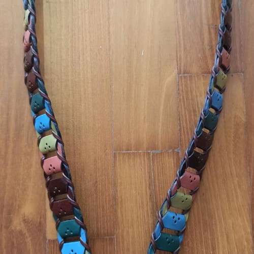 Colorful woven belt in warm shades made of faux leather, like new