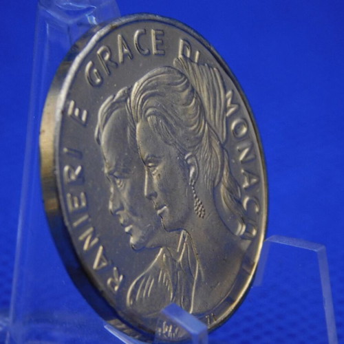 Commemorative metal token with Prince Rainier and Grace Kelly of Monaco