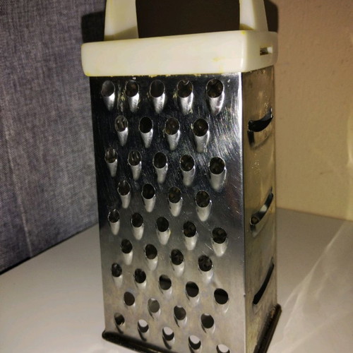 Cheese grater used, stainless steel with plastic handle