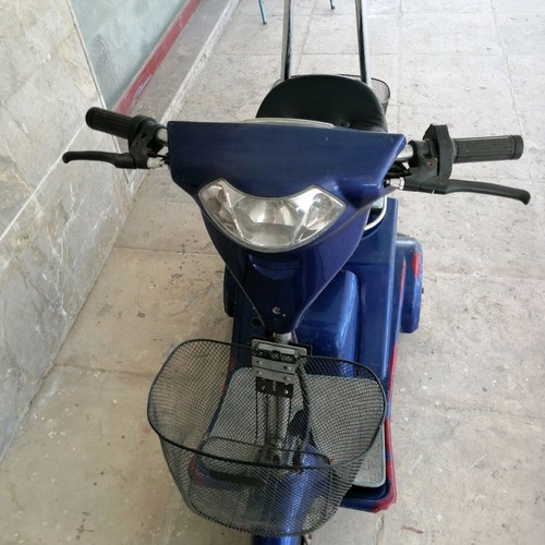 Electric three-wheeler used with two baskets and hill assist