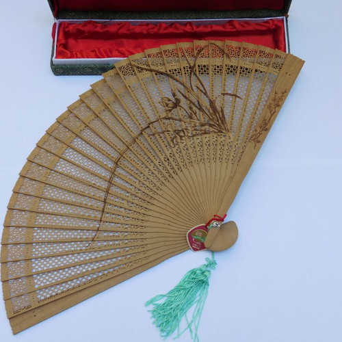 Traditional Chinese sandalwood fan with decorative tassel