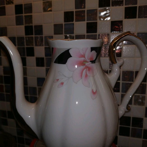 Vintage teapot used with gold details, missing lid