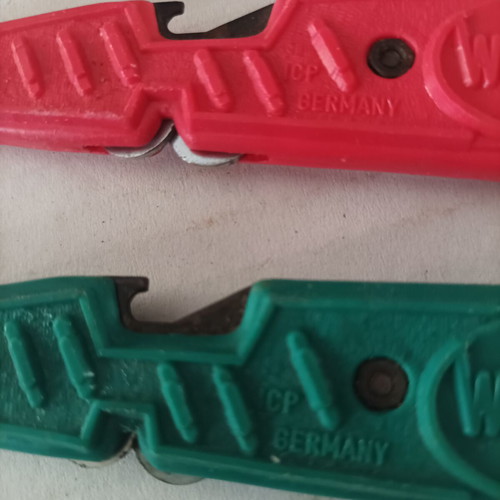 Various tools used including cable strippers, vintage bicycle wrench, glass cutter