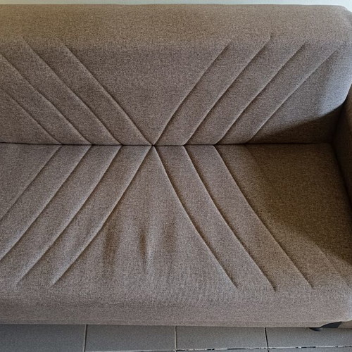 Two-seater sofa bed with storage space