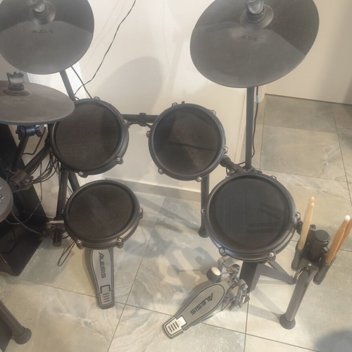 Alesis Nitro Mesh Kit electronic drums with Sony headphones and drumsticks holder