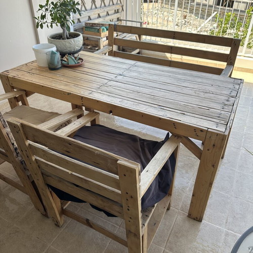 Handmade wooden table set with chairs and bench used