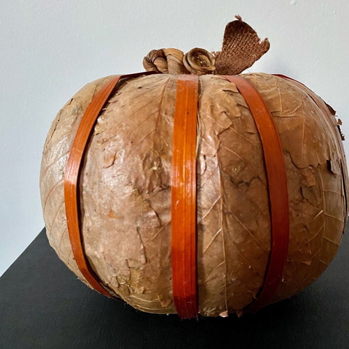 Decorative pumpkin wrapped with dried leaves like new