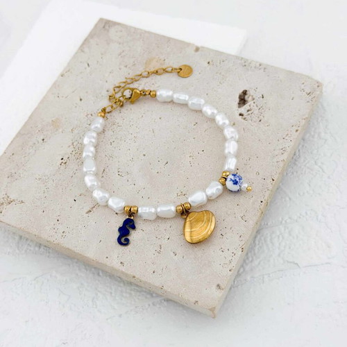 Bracelet with beads and charms made of stainless steel like new, white and gold